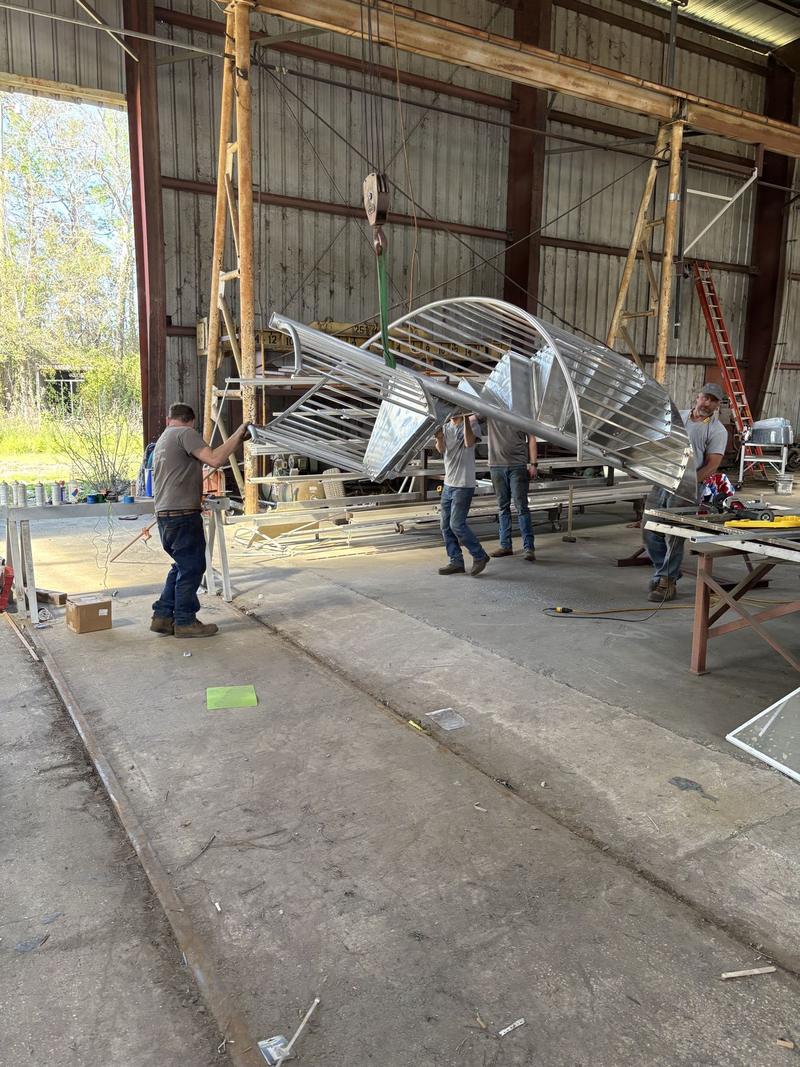 Crew assembling a spiral staircase in the shop